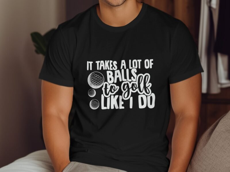 A person wearing a black t-shirt with the text "It takes a lot of balls to golf like I do" and golf ball graphics.