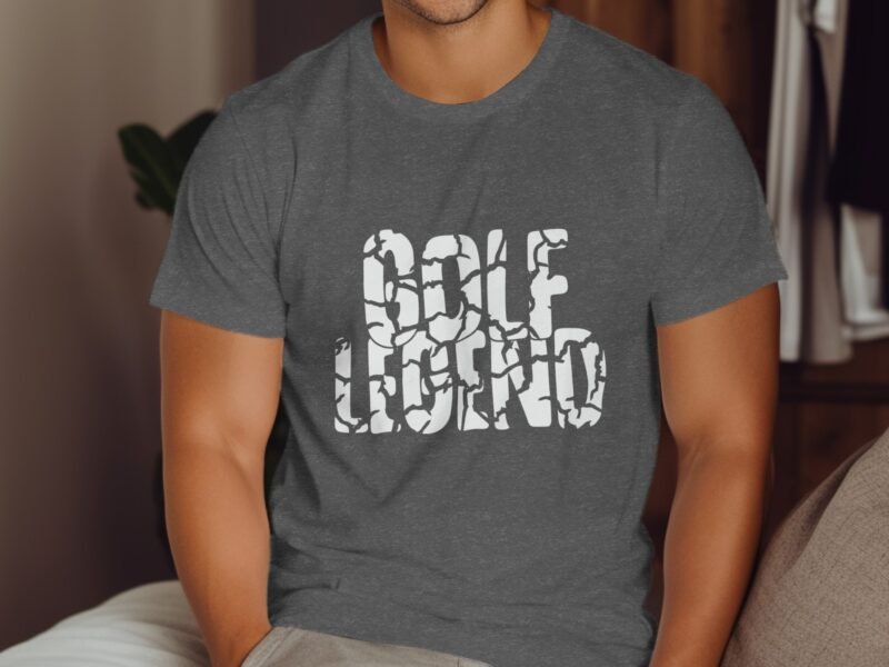 A person wearing a gray t-shirt with the text "GOLF LEGEND" in white, sitting on a couch.