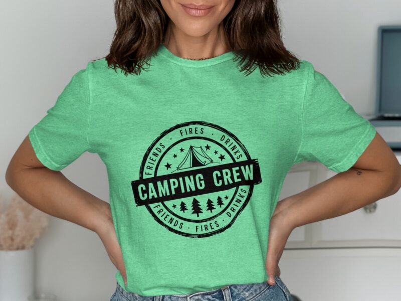 A woman wearing a green t-shirt with "Camping Crew" printed on it, showcasing a camping-themed design.