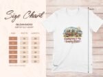 Size chart for Gildan 64000 softstyle T-shirt featuring "Camping is my happy place" design with camper illustration.