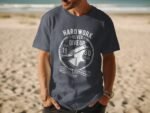 Man wearing a navy blue t-shirt with a graphic design featuring an anvil and the text "Hard Work Never Give Up."