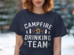 A person wearing a navy t-shirt with "Campfire Drinking Team" text, featuring trees, flames, and drink icons.