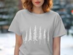 Woman wearing a light gray t-shirt with a white forest of pine tree silhouettes printed across the front.