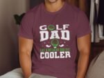 A man wearing a maroon t-shirt with "Golf Dad" graphic and text "Like a regular dad but cooler." Background is neutral.