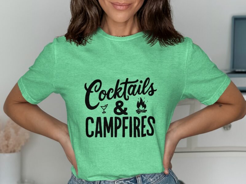Woman wearing a green t-shirt with the text "Cocktails & Campfires" in bold black font.