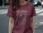 Woman wearing a maroon t-shirt with a vintage motorcycle graphic and "Café Racer" text, standing on a city street.