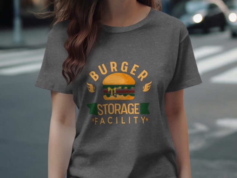 A person wearing a gray t-shirt featuring a colorful burger graphic with the text "BURGER STORAGE FACILITY."