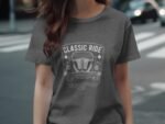 A woman wearing a gray t-shirt with a vintage car graphic and the text "CLASSIC RIDE" on a city street.