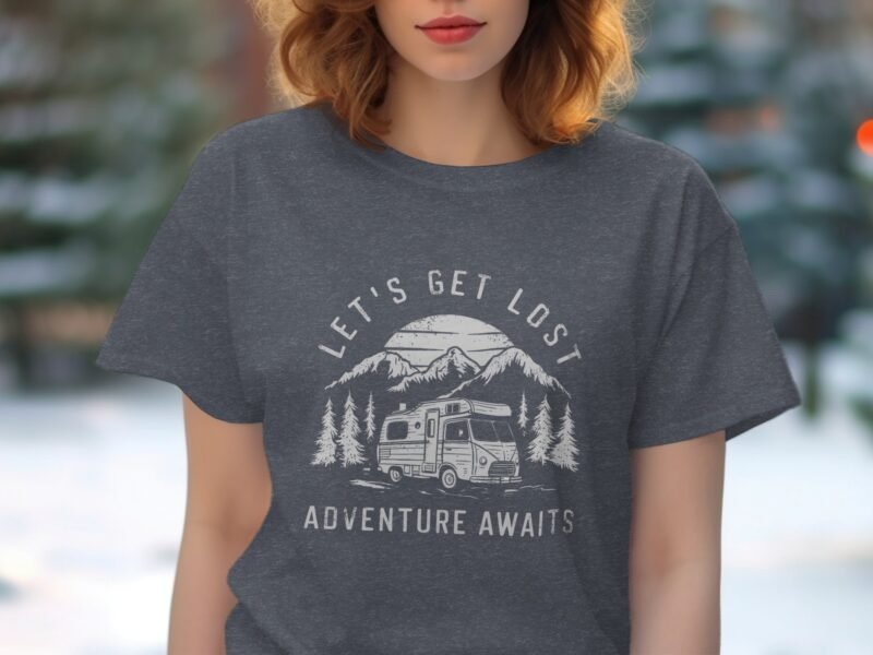 A woman in a gray t-shirt featuring a camping graphic with the text "Let's Get Lost Adventure Awaits."