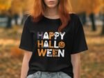 A woman in a black t-shirt with "Happy Halloween" text, surrounded by autumn foliage.