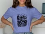 Woman wearing a light blue t-shirt with the text "Life is a climb but the view is great" and mountain graphics.