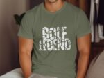 A man wearing an olive green t-shirt with "GOLF LEGEND" printed in bold, white, cracked lettering.