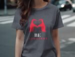 A person wearing a dark gray t-shirt with a red graphic design reading "BE YOUTIFUL" and two stylized figures.