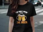 A person wearing a black t-shirt with the phrase "I'm only here for THE BEER" and two beer mugs graphic.