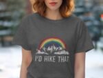 Woman wearing a gray t-shirt with a rainbow and mountain graphic, text reads "I'd Hike That."