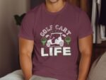 Man wearing a maroon t-shirt with "GOLF CART LIFE" graphic and green golf-related designs.