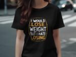 A person wearing a black t-shirt with the phrase "I would lose weight but I hate losing" in bold white and yellow text.