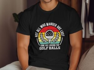A man in a black t-shirt features a colorful graphic with the text about wandering and golf balls.