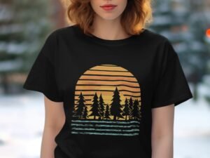 A woman in a black t-shirt featuring a sunset design with stripes and silhouetted trees. Soft focus background.