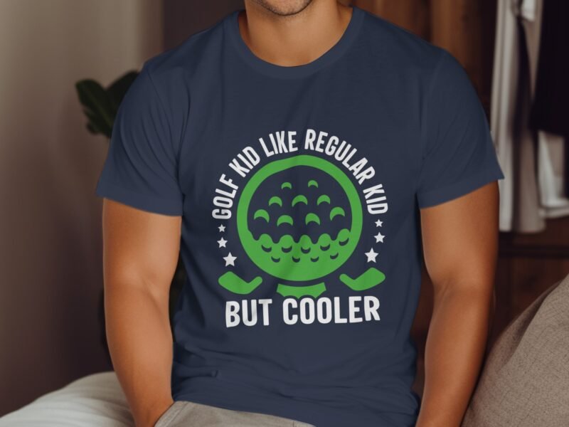A person wearing a navy blue t-shirt with green and white text that reads "GOLF KID LIKE REGULAR KID BUT COOLER."