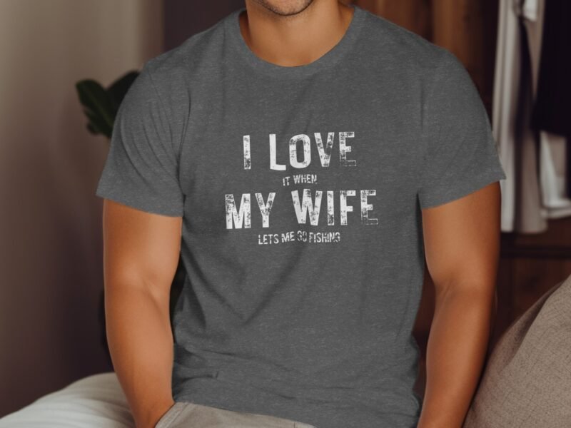 Man wearing a gray t-shirt with the text "I LOVE IT WHEN MY WIFE LETS ME GO FISHING" printed on it.
