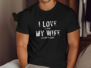 Man wearing a black t-shirt with the text "I LOVE IT WHEN MY WIFE LETS ME GO FISHING" displayed prominently.