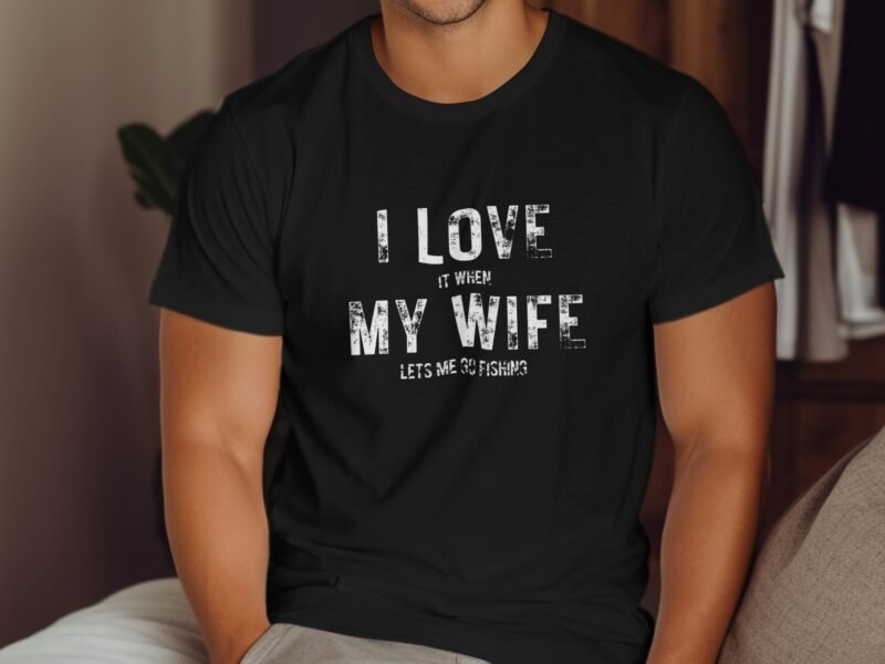 Man wearing a black t-shirt with the text "I LOVE IT WHEN MY WIFE LETS ME GO FISHING" displayed prominently.