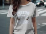 A woman in a light gray t-shirt with the words "PISTON BROKE" and two bottle graphics stands on a street.