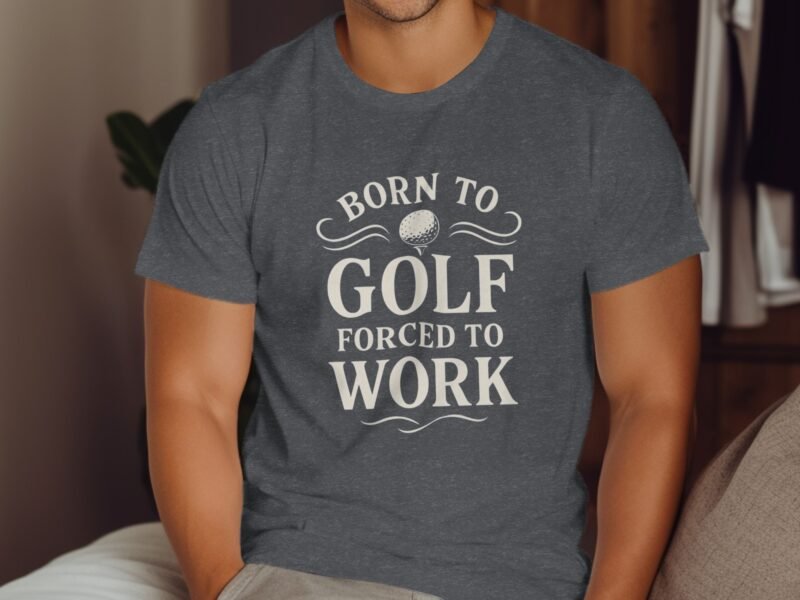A person wearing a gray t-shirt with the text "BORN TO GOLF FORCED TO WORK" displayed prominently on it.