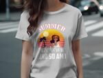 Woman wearing a light gray t-shirt with a summer-themed graphic featuring a sun, palm trees, and the text "Summer is here and so am I."