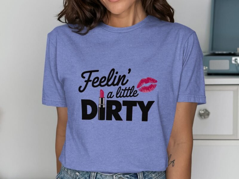 Woman in a lavender shirt with "Feelin' a little DIRTY" graphic and lipstick illustration, smiling.