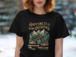 A woman wears a black t-shirt with an outdoor-themed graphic and the phrase "Happiness is Being Outdoors."