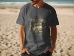 Man wearing a dark gray t-shirt with a vintage truck graphic and text saying "Fuel for the Soul" on a beach.