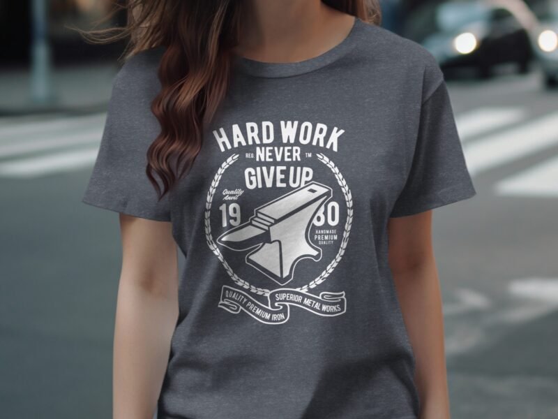 A person is wearing a gray t-shirt featuring the text "Hard Work Never Give Up" and an anvil graphic.