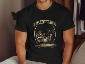 A person in a black t-shirt with a fishing graphic sits casually, looking relaxed in a cozy indoor setting.