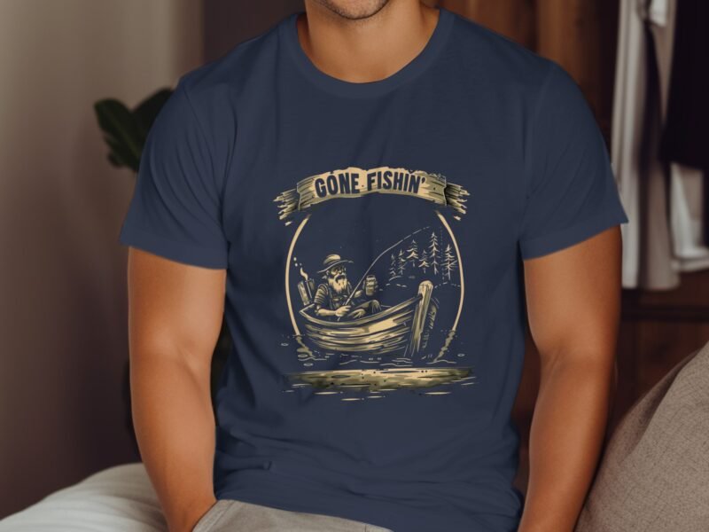 A man wearing a navy t-shirt with a vintage fishing graphic and the text "Gone Fishin'" sits indoors.