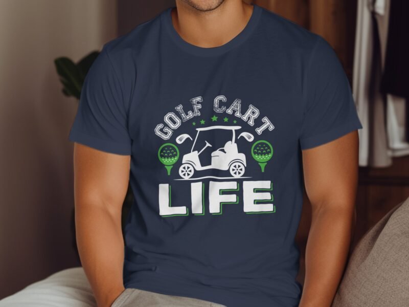 A man wearing a navy shirt with "GOLF CART LIFE" text and golf-themed graphics, seated indoors.