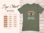 Size chart for Gildan 64000 softstyle t-shirt, showcasing measurements and a graphic design with hiking theme.