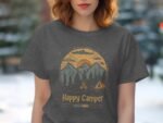 Woman wearing a dark gray t-shirt featuring a "Happy Camper" graphic with mountains, trees, and a campfire design.