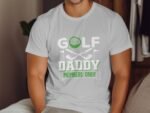White t-shirt featuring "GOLF DADDY MEMBERS ONLY" text with a golf ball and crossed clubs design.