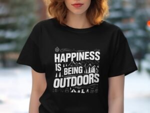 A person wearing a black t-shirt with the text "Happiness is being outdoors" and nature graphics against a blurred background.