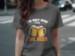 Woman wearing a gray t-shirt with a graphic of two beer mugs and the text "I'm only here for THE BEER."