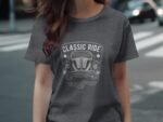 A woman wearing a gray t-shirt with a vintage car graphic and text reading "Classic Ride" walks on a crosswalk.