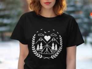 A woman in a black t-shirt featuring a white camping-themed graphic with mountains, trees, and a heart.