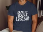 A man wearing a navy blue t-shirt with the text "Golf Legend" in a stylized cracked font, sitting on a couch.