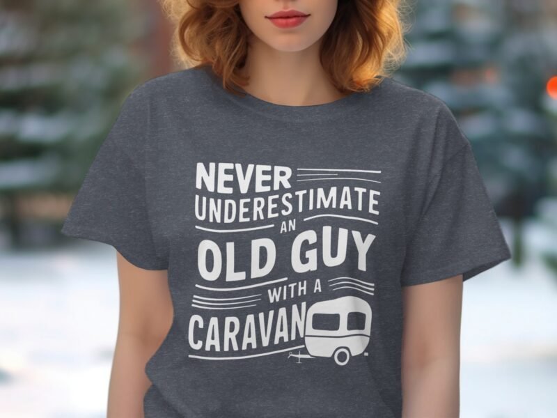 A woman wearing a gray t-shirt with the phrase "Never underestimate an old guy with a caravan" and a caravan graphic.