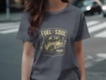 Woman wearing a gray t-shirt with a vintage car graphic and the text "Fuel for the Soul, Garage Built, Est. 1938."
