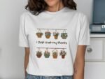 A woman wearing a white t-shirt with colorful hanging planters and the text "I Just Wet My Plants."