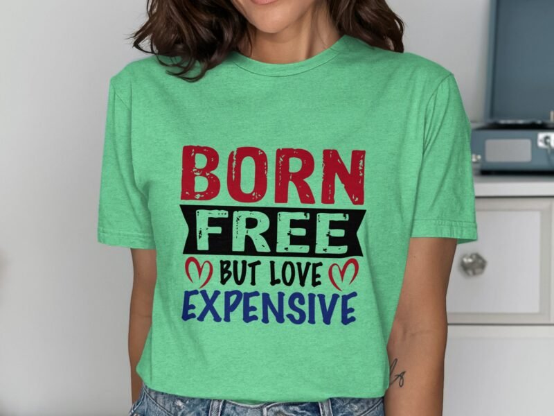 Model wearing a mint green t-shirt with colorful text: "BORN FREE BUT LOVE EXPENSIVE." Background features furniture.
