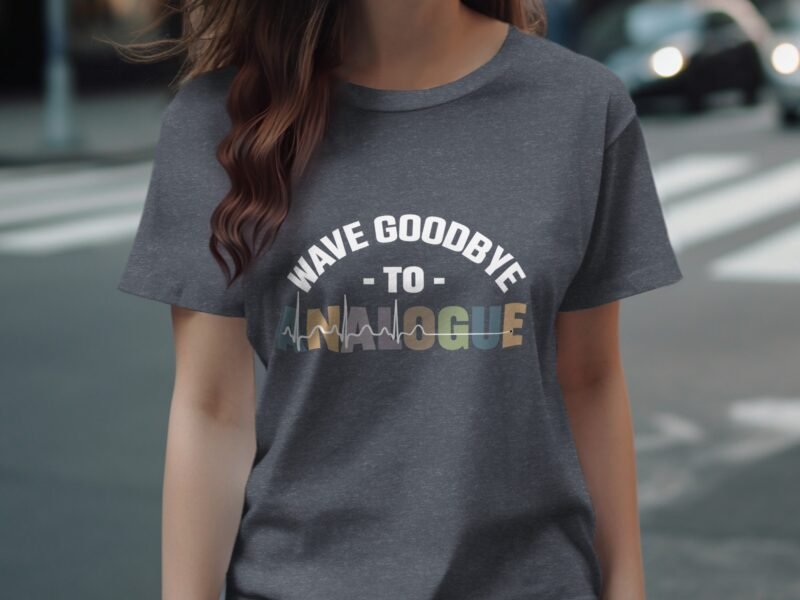 A woman wearing a gray t-shirt with the text "WAVE GOODBYE TO ANALOGUE" and a graphic design.